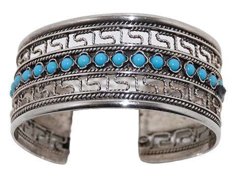 Wide silver bangle with blue stones