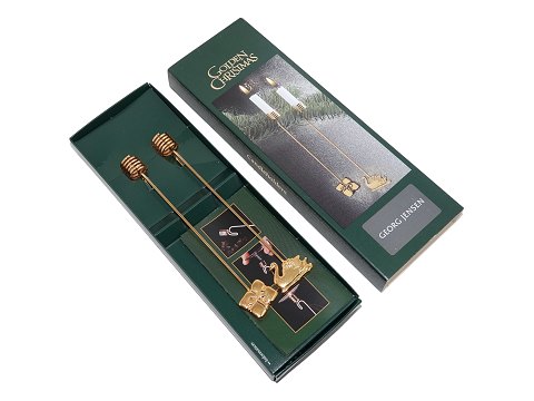 Georg Jensen Christmas
Two Golden Christmas Candle holders - Swan and gift from 2000