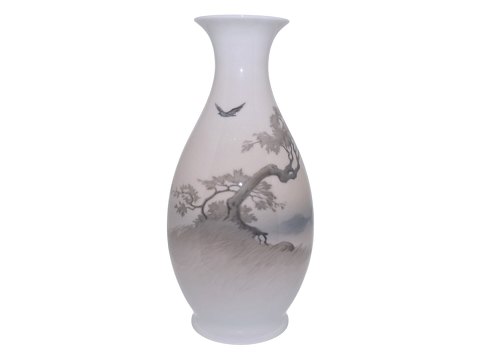 Royal CopenhagenLarge vase featuring a large tree by the water and a flying bird from 1923–1928.